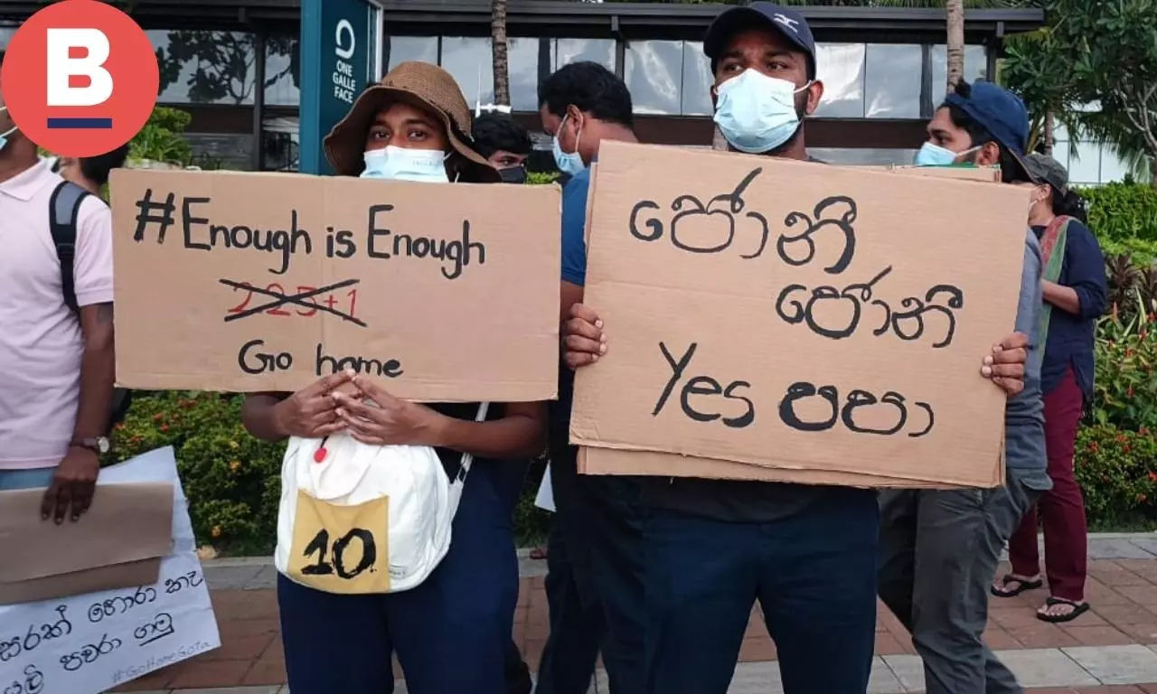 Give back the stolen money reads the placard written in Sinhala